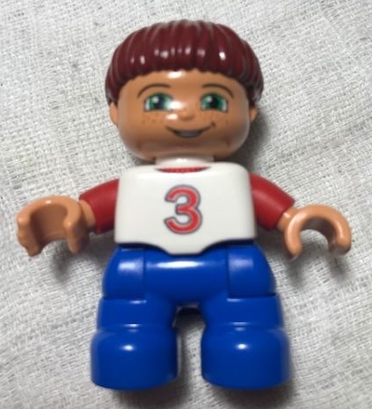 Duplo Figure Lego Ville, Child Boy, Blue Legs, White Top with Red Number 3 Pattern, Dark Red Hair (6013303)